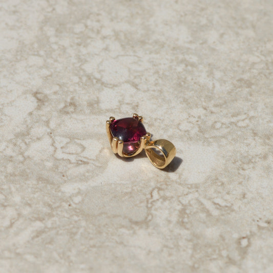 Vintage Buff-top Garnet Charm