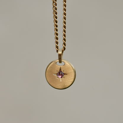 Round star-set charm, sapphire cabochon