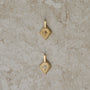 Two lozenge-shaped tag pendants with star set round brilliant cut diamonds, one champagne color, one white