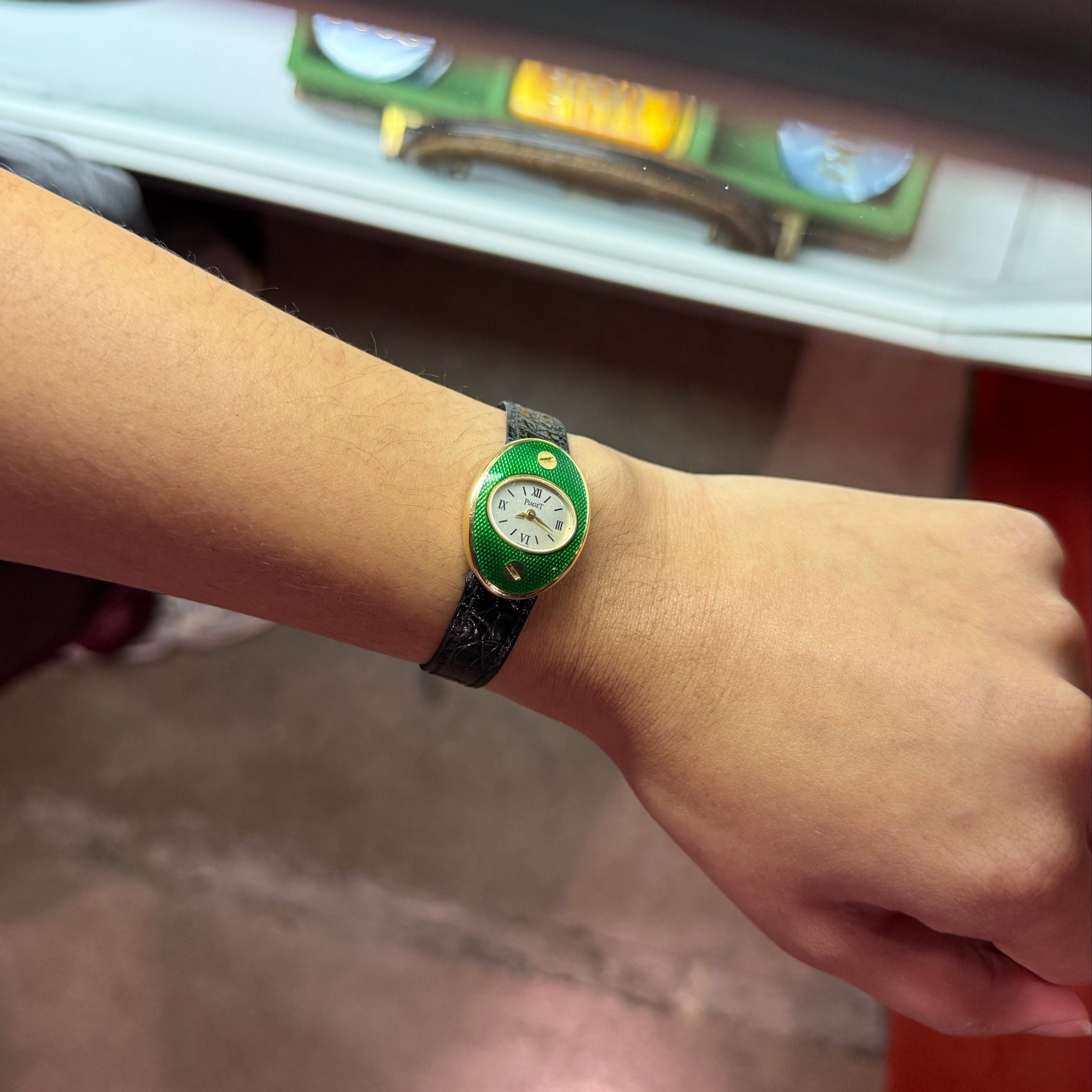 Person wearing a vintage green enamel Piaget watch