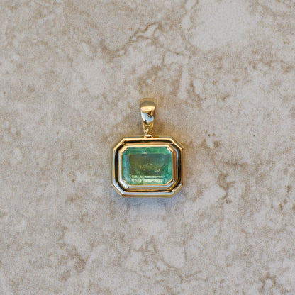 Natural emerald pendant bezel-set in chunky 14k gold 