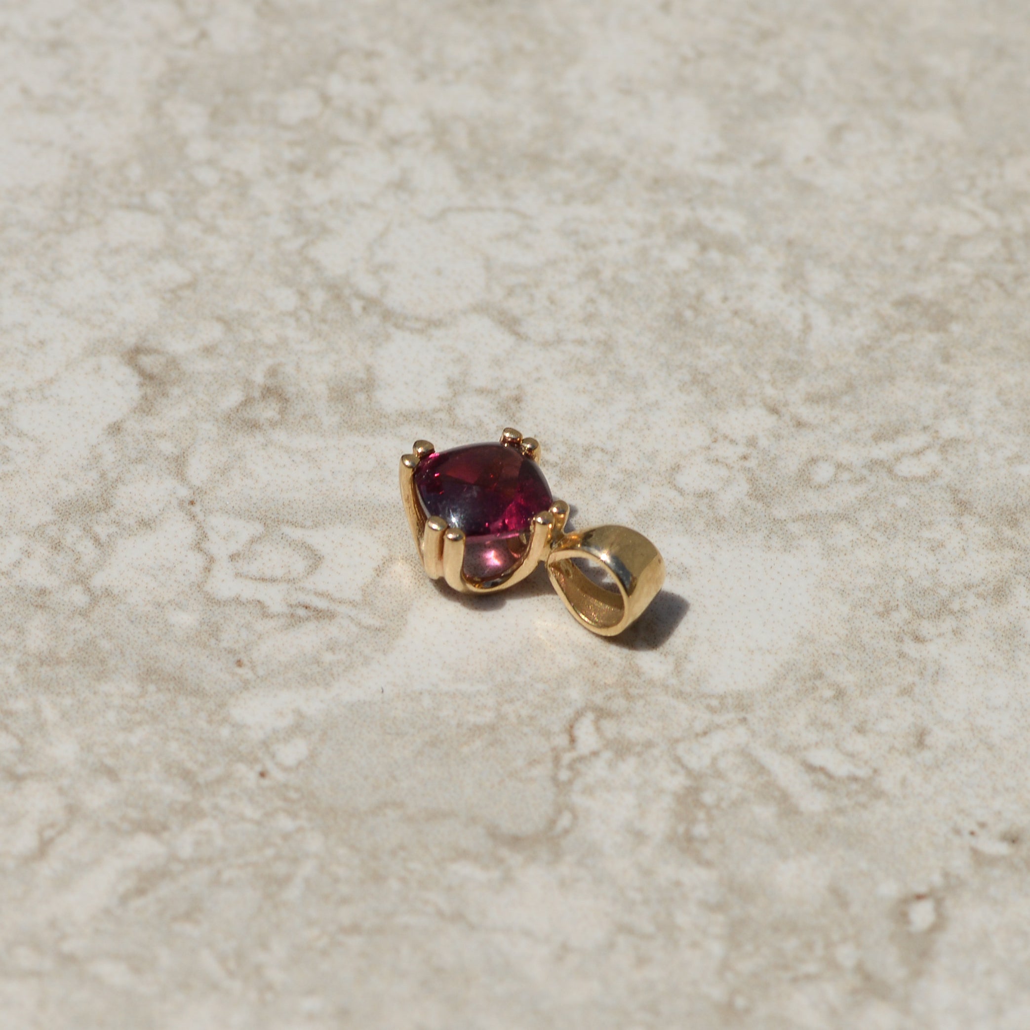 Vintage Buff-top Garnet Charm