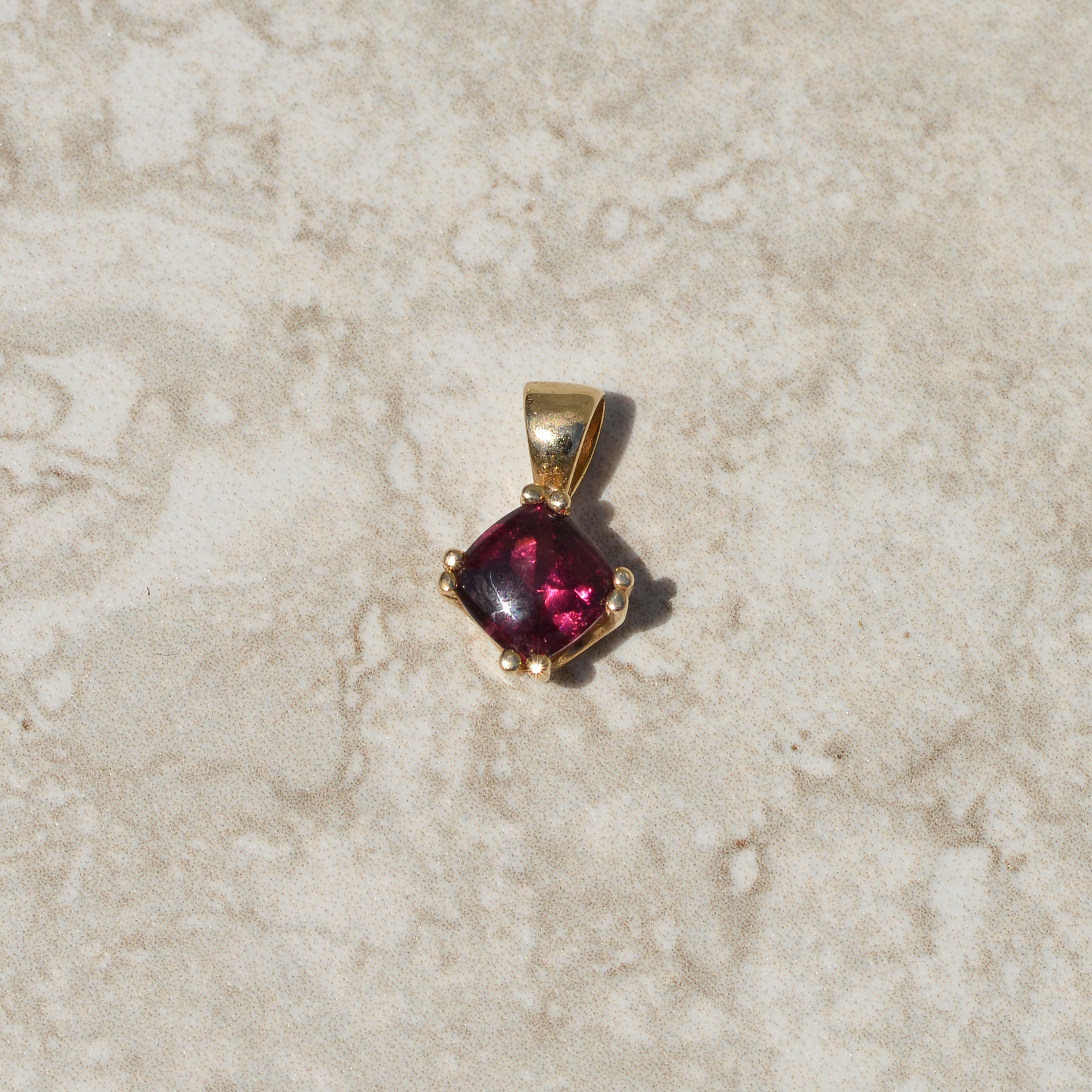 Vintage Buff-top Garnet Charm