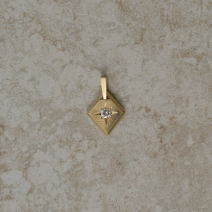 Lozenge-shaped tag pendant with star set round white round brilliant cut diamond