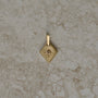 Lozenge-shaped tag pendant with star set round champagne round brilliant cut diamond