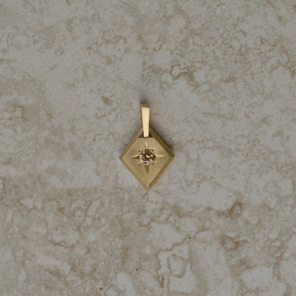 Lozenge-shaped tag pendant with star set round champagne round brilliant cut diamond