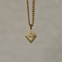 Lozenge-shaped tag pendant with star set round white round brilliant cut diamond