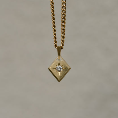 Lozenge-shaped tag pendant with star set round white round brilliant cut diamond