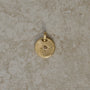 Round-shaped tag pendant with star set champagne round brilliant cut diamond