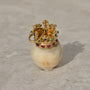 Carved bone skull pendant with diamond eyes and 14k gold crown set with diamonds, rubies, emeralds, and sapphires.