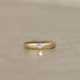 14k gold square band ring with a brushed finish and flush set with a 0.25 carat old mine cut diamond