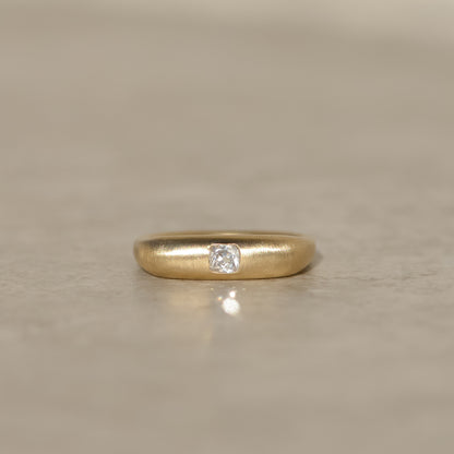 14k gold square band ring with a brushed finish and flush set with a 0.25 carat old mine cut diamond